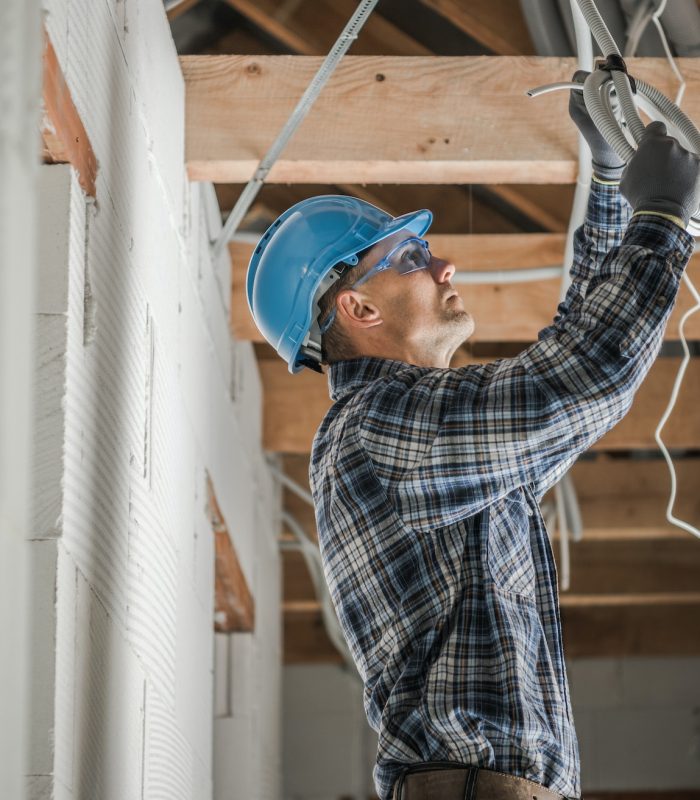 Professional Electrician Installing Ceiling Light Point